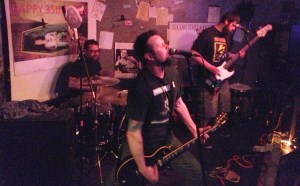 Third Wounded Man makes Cafe Acoustic's neighbors angry on 4/13/13. Left to right: Bill Blizzard, Todd Cooper and Tyson Bottorff.